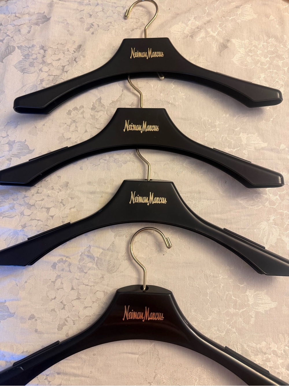 A bundle of 4 Neiman Marcus Black and Gold Branded  Hanger